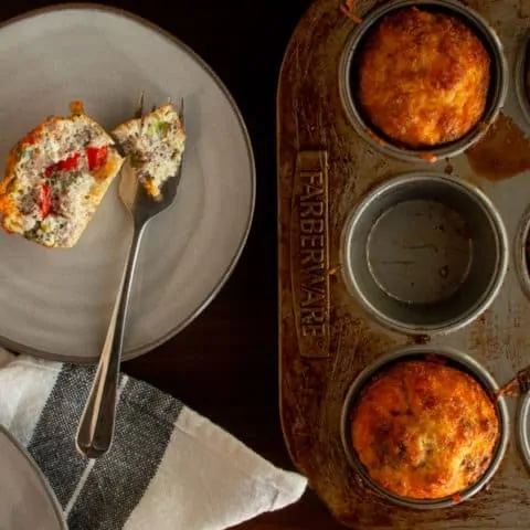 Muffin Tin Egg Bites in tin with serving beside on plate