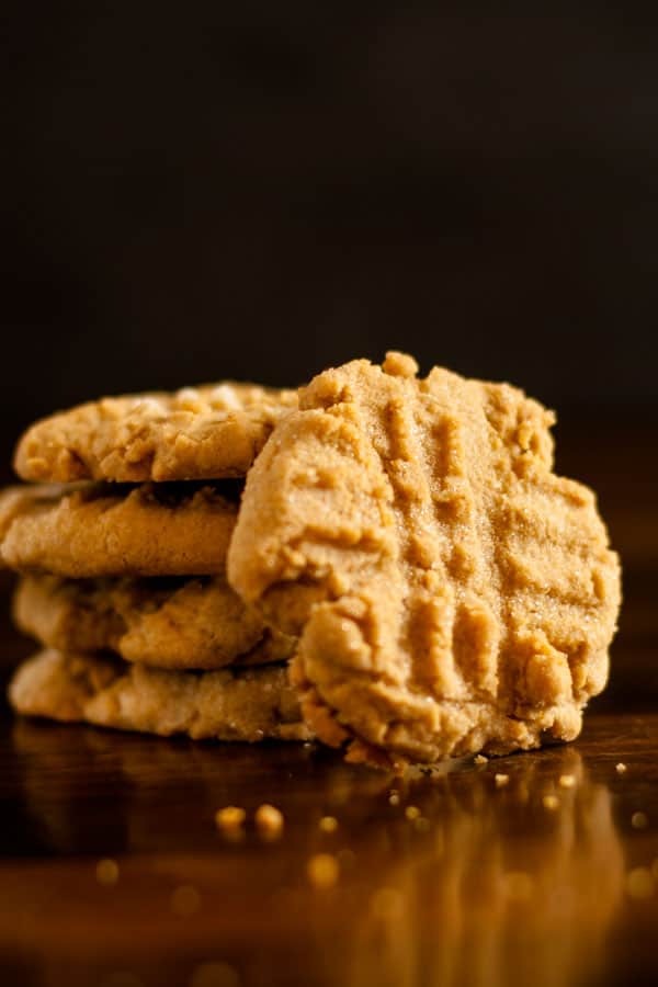 Gluten Free Peanut Butter Cookies in a stack with featured cookie leaning along side