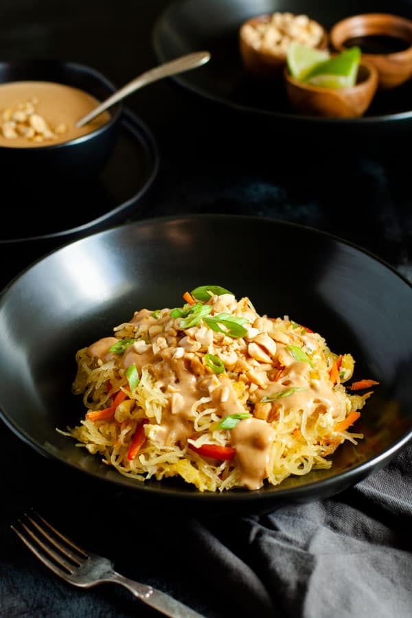 Spaghetti Squash Pad Thai topped with peanut sauce and crushed peanut garnish