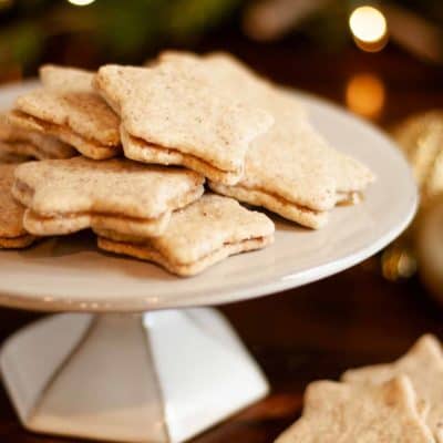 Gluten Free Pecan Shortbread Cookies finished and filled with caramel filling on display surrounded by holiday lights