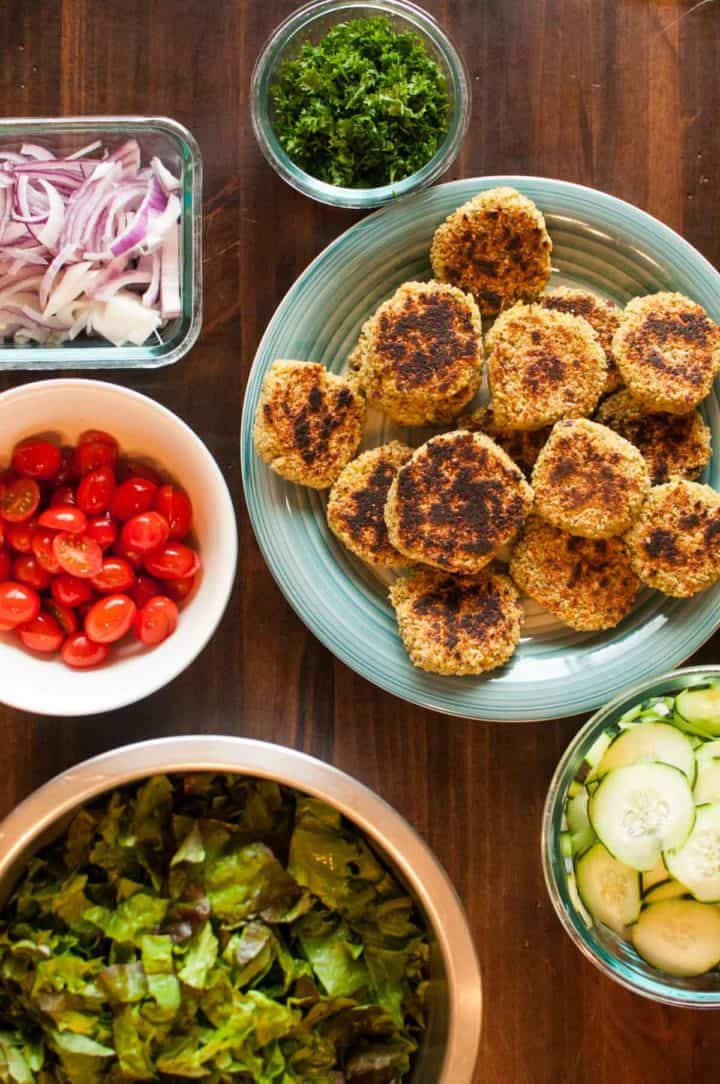 Ingredients laid out in dishes on table ready to assemble the falafel salad fresh