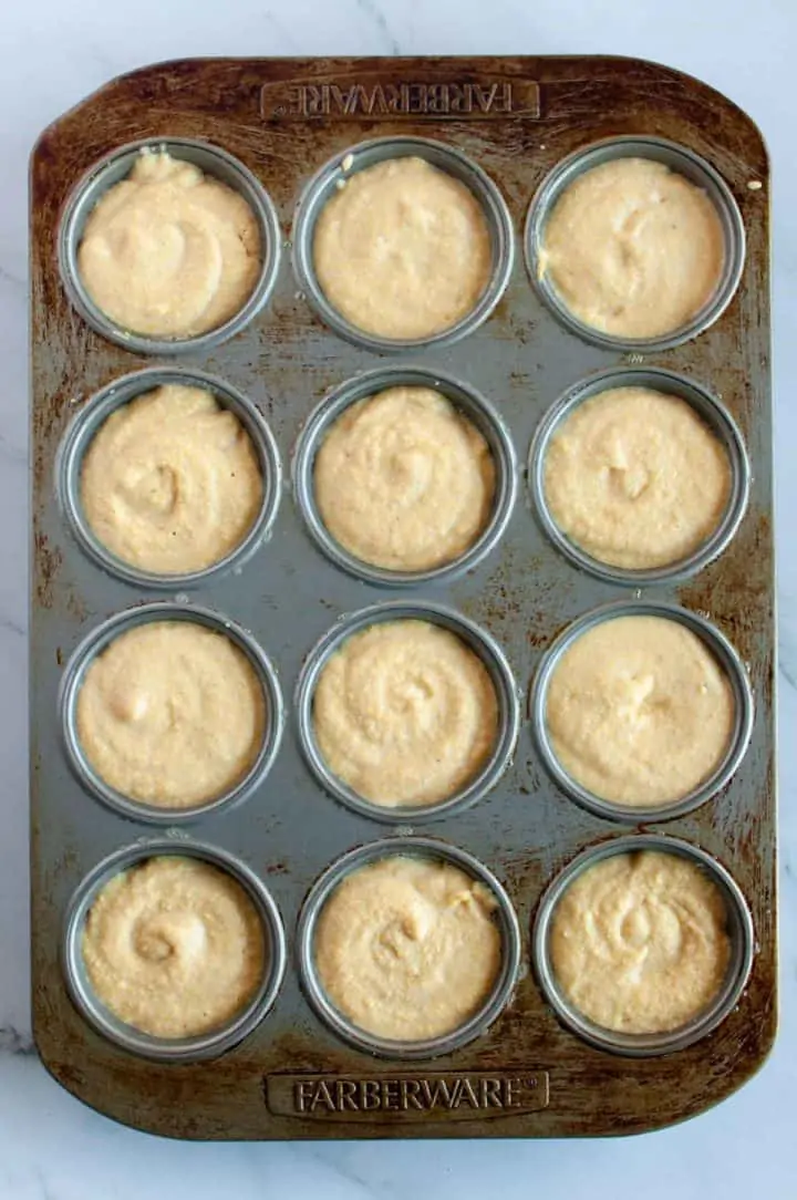 cornbread muffin batter in muffin tin ready for oven