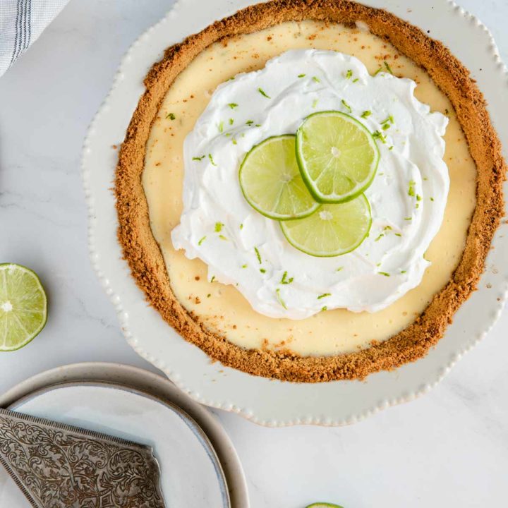 recipe card image for gluten free key lime pie displayed in pan ready to be served.