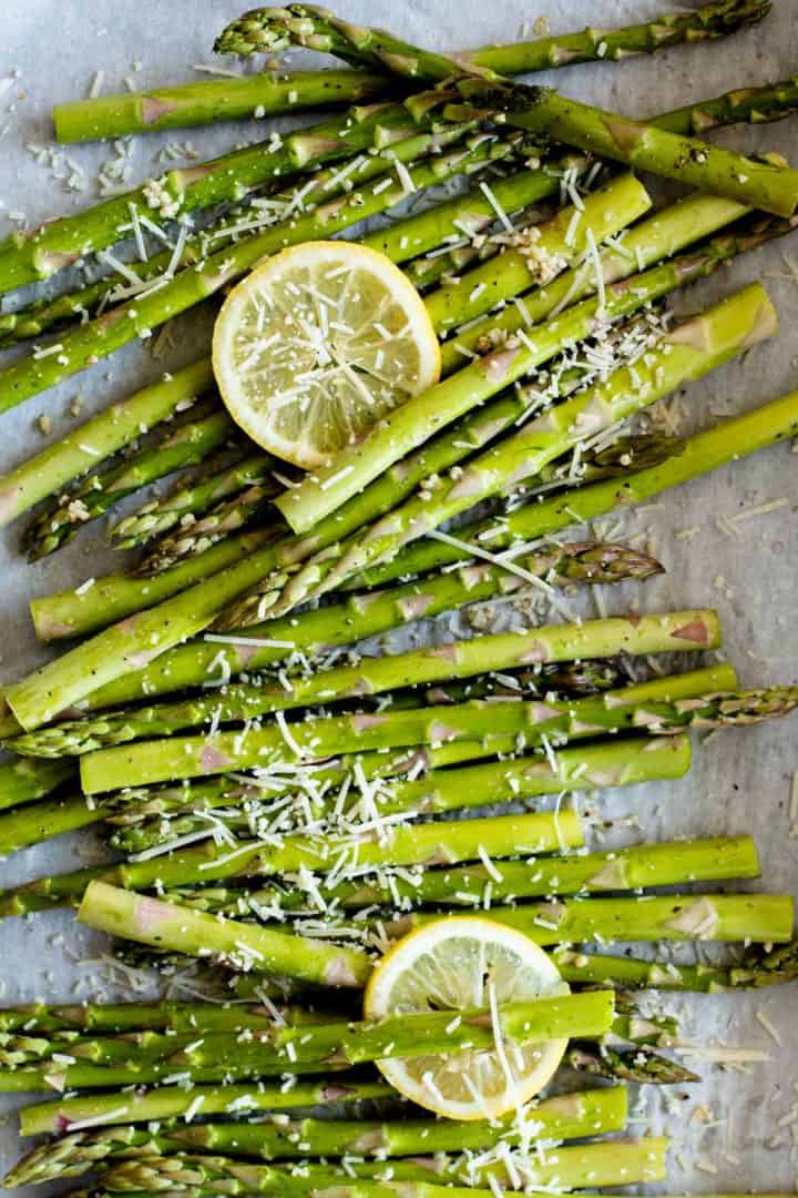 Asparagus oven ready prepared with parmesan cheese, roasted garlic and lemon slices