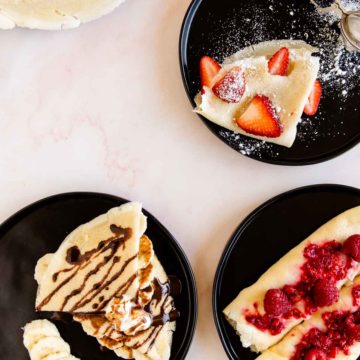 gluten free french crepes served with different toppings, like banana and chocolate suace, ricotta filling, or berries and powder sugar