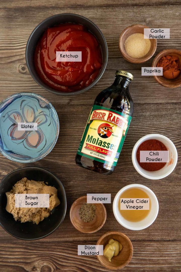 Ingredients needed for homemade barbecue sauce laid out and displayed on a wooden surface